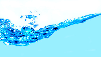 Close up wave blue Water splash with air bubbles on white background for effect and wallpaper.