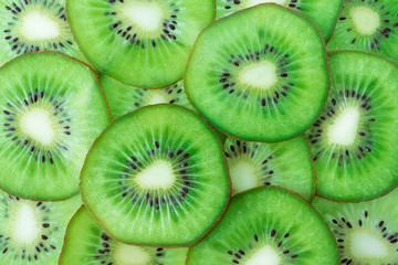Kiwi fruit slices pattern top view. Fresh juicy food background. Macro concept