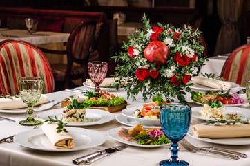 Beautiful restaurant interior table decoration for wedding or event. Flower Wedding Table Decoration, Autumn colors. European food in a restaurant setting. Table set for party.