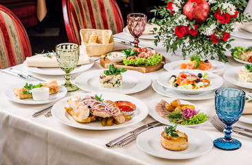 Beautiful restaurant interior table decoration for wedding or event. Flower Wedding Table Decoration, Autumn colors. European food in a restaurant setting. Table set for party.