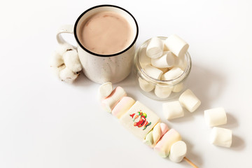 Cup of hot flavored cocoa with marshmallows on a  white background. Christmas composition with cocoa. Cozy home mood.
