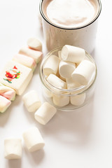 Cup of hot flavored cocoa with marshmallows on a  white background. Christmas composition with cocoa. Cozy home mood.