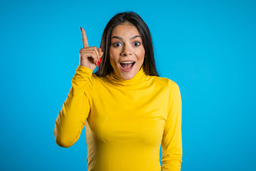 Smiling happy student girl showing eureka gesture. Portrait of young thinking pondering business...