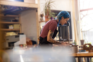 Confident young craftswoman in her workshop
