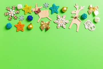 Top view of green background with New Year toys and decorations. Christmas time concept with copy space