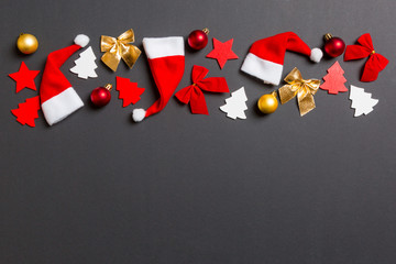 Top view of black background with New Year toys and decorations. Christmas time concept with copy space