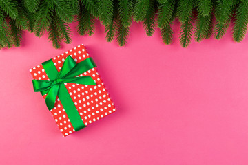 Top view of colorful holiday background made of fir tree and gift box. Happy New Year concept with copy space