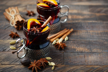 Mulled Wine with Oranges and Spices on the Old Wooden table.