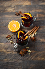 Mulled Wine with Oranges and Spices on the Old Wooden table.