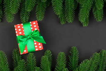 Top view of colorful holiday background made of fir tree and gift box. Happy New Year concept with copy space