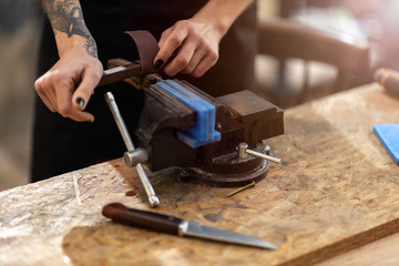 Female carpenter working on a vice grip 