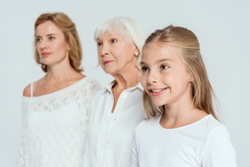 selective focus of granddaughter, mother and grandmother on background isolated on grey