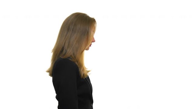 Side view of blond woman standing on isolated white background wearing business clothes corporate attire thinking deeply and meditating. Close up of lady employee or manager