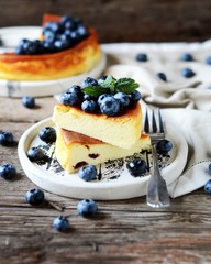 Cottage cheese casserole with blueberries on a wooden background