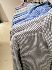 multi-colored men's shirts on a hanger
