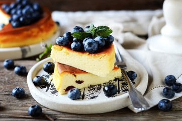 Cottage cheese casserole with blueberries on a wooden background