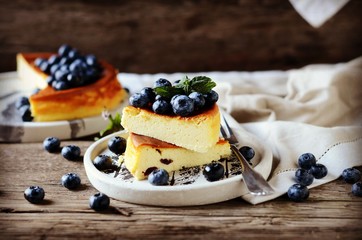 Cottage cheese casserole with blueberries on a wooden background