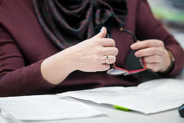 businessman using hand sign while talking to his colleague in office.