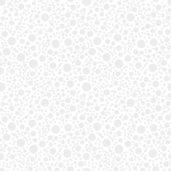 Seamless background made of light gray circles of different sizes placed chaotic on white