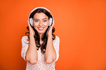 Portrait of positive cheerful girl listen music wear white head phone feel pleasure emotions wear stylish clothing isolated over shine color background
