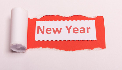 White torn paper with New Year text with red background color. Hidden message. Secret. Copy space.