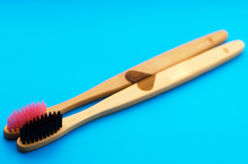 eco natural bamboo toothbrushes on blue background. zero waste flat lay.