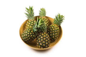 Pineapple in a bowl isolated om white.
