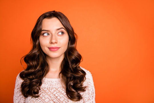 Portrait of interested girl think thoughts about her weekends look copy space wear knitted blouse isolated over orange color background