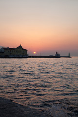 Fototapeta premium a vibrant blue and golden sunset in the swirling clouds of the izmir-Turkiye