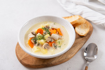 Homemade chicken vegetable soup in bowl with toast slices. Ketogenic dieting, nutrition