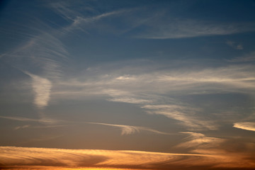 a vibrant blue and golden sunset in the swirling clouds of the izmir-Turkiye