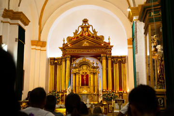 People praying at Mass in Catholic Church - Cathedral San Jose Antigua Guatemala inside - Baroque...