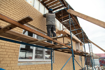 Installation of siding on the walls of the house