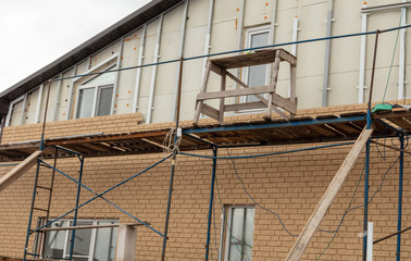 Installation of siding on the walls of the house