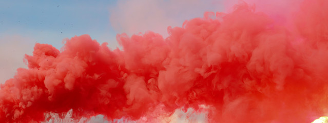 Red smoke on a blue sky