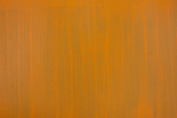 Orange-green paint strokes on a flat surface. Copy space