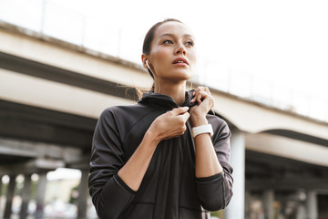 Strong fitness concentrated woman at the street.