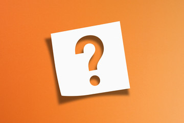 Note paper with question mark on orange background