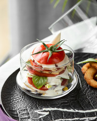sliced tomato filled with white cheese