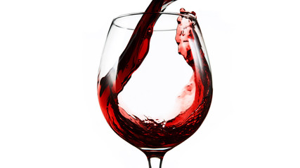 Detail of pouring red wine into glass on white