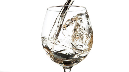 Detail of pouring white wine into glass on white
