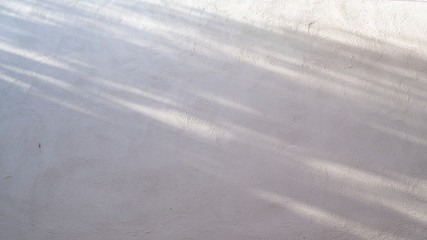 Abstract gray shadow background of natural shading falling on white cement concrete wall texture for background and wallpaper, black and white monochrome tone . idea for decorate home atmosphere