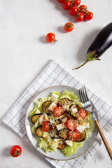 Grilled Aubergine with Feta, cherry tomatoes and Rocket salad. Keto diet, healthy nutrition. Top view. Restaurant menu