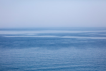 Blue expanse of water at sea as abstract background