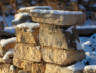Stone bricks in the snow in winter at dawn