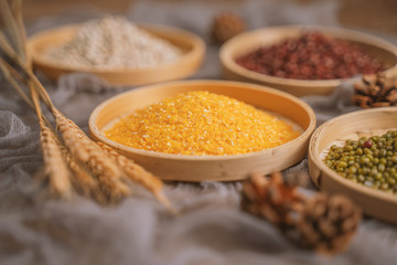 Chinese traditional grains in chinese steamer on wooden table. Made of maize, mung bean, chinese red bean. Chinese traditional food concept
