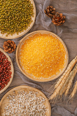Chinese traditional grains in chinese steamer on wooden table. Made of maize, mung bean, chinese red bean. Chinese traditional food concept