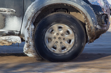 Car wheel in the snow in winter