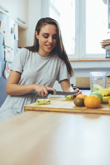 woman preparing food for fruit salad in her kitchen