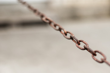 Old iron chain. Close-up of a rusty metal chain located diagonally in a frame. Abstract background....